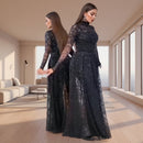 Woman wearing a black sequin dress against a neutral background