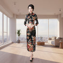 Woman in a floral dress standing in a room with decorative elements.